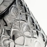 Close-up of transparent glass object with textured star pattern, suitable for decorative lighting and design