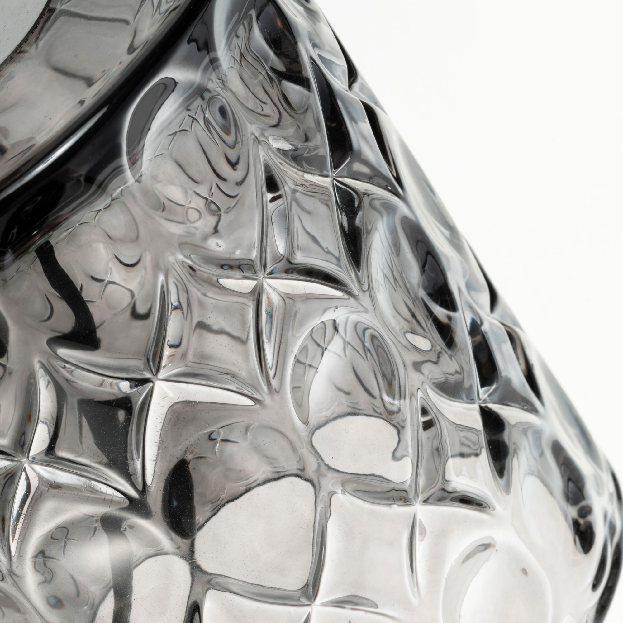 Close-up of transparent glass object with textured star pattern, suitable for decorative lighting and design