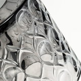 Close-up of transparent glass object with textured star pattern, suitable for decorative lighting and design