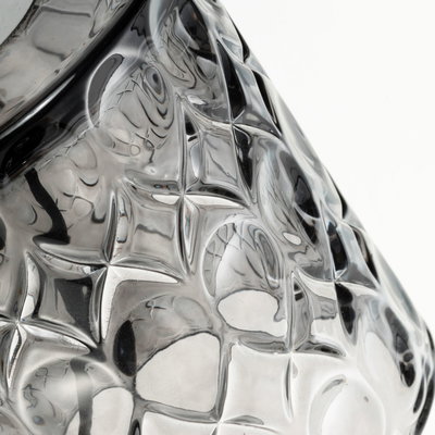 Close-up of transparent glass object with textured star pattern, suitable for decorative lighting and design