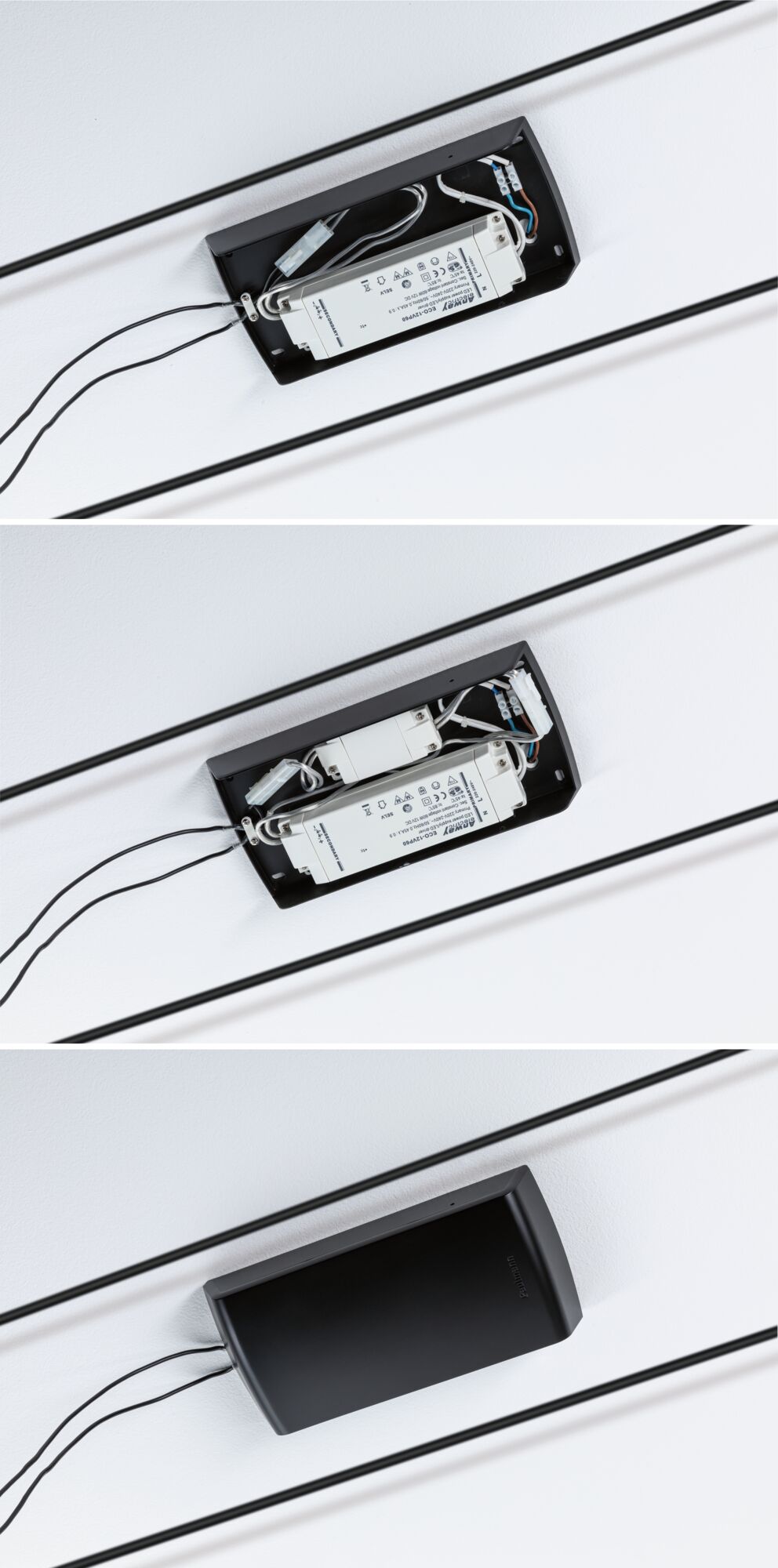 Sort dæksel til LED-driver med synlig hvid elektronisk forkobling og ledningsforbindelser i loftet