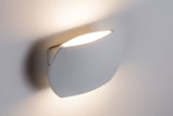Modern white metal wall light with warm white illumination for ambient indoor lighting