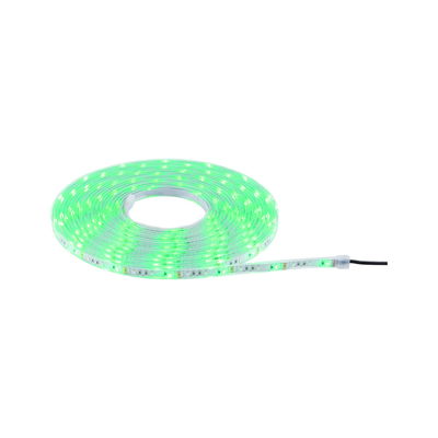 Green glowing LED strip light on roll with flexible plastic material for decorative lighting use.