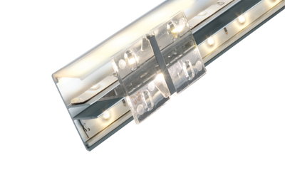 Close-up of silver aluminum LED profile with frosted diffuser and clear mounting clip for lighting setups