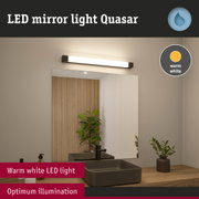 Quasar warm white LED mirror light above bathroom sink with wooden decor and modern faucet