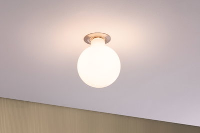 Round ceiling light with white glass and metal base, modern LED lighting for living spaces