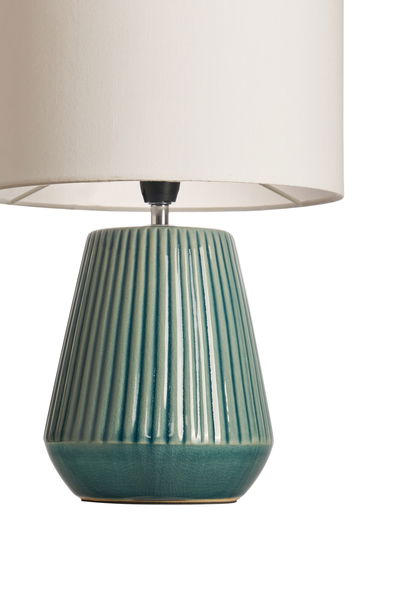 Table lamp with green ceramic base and white fabric shade for elegant home lighting