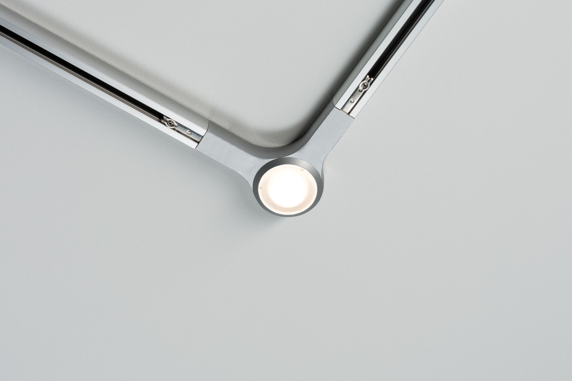 Modern silver LED ceiling spotlight with two arms and central light for living spaces