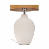 Table lamp with white ceramic base and brown fabric shade for elegant home lighting