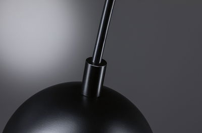 Black metal lampshade with rod in minimalist modern indoor lighting fixture