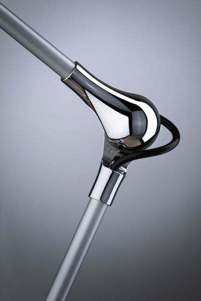 Close-up of silver metal rod with shiny chrome connector and black cable for LED lighting fixture