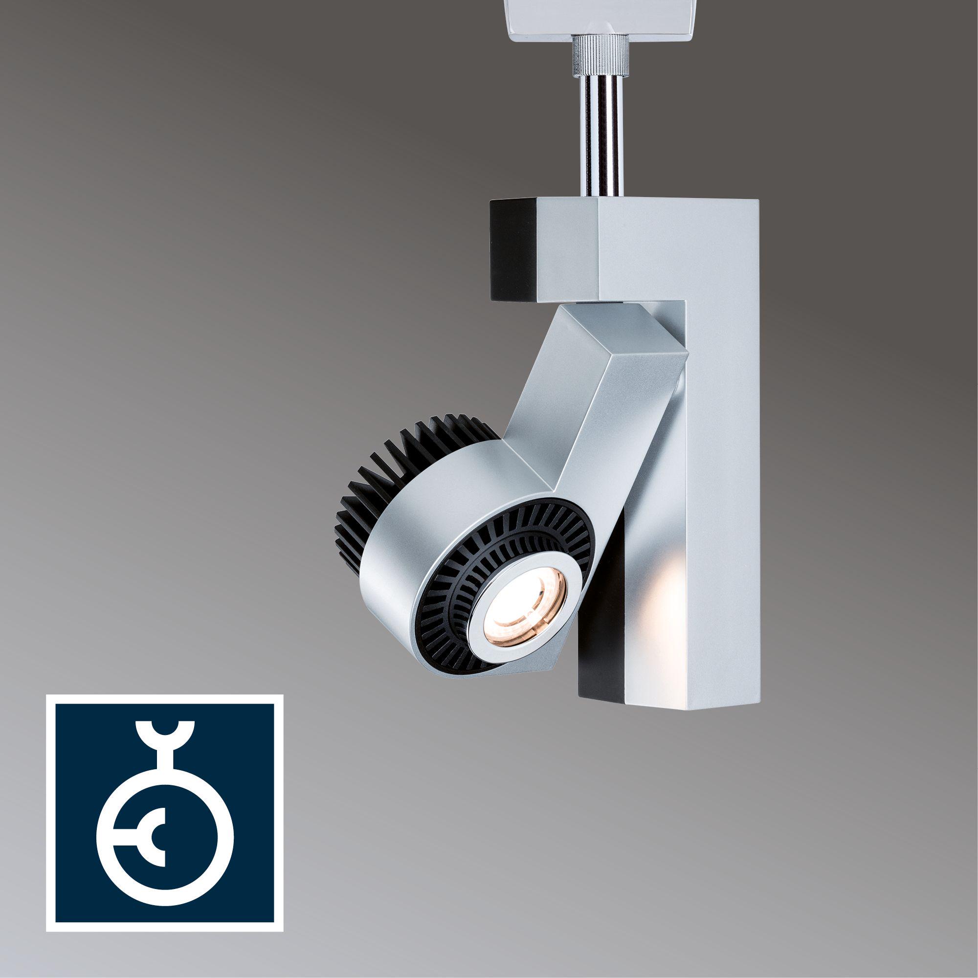 Projecteur LED moderne en métal argenté avec dissipateur thermique noir pour éclairage réglable.