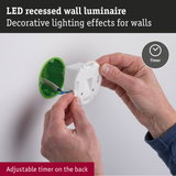 LED recessed wall luminaire with white plastic housing and green mounting box, adjustable timer on back