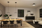 Salle à manger moderne avec suspensions et plafonnier noirs au design minimaliste et table en bois.