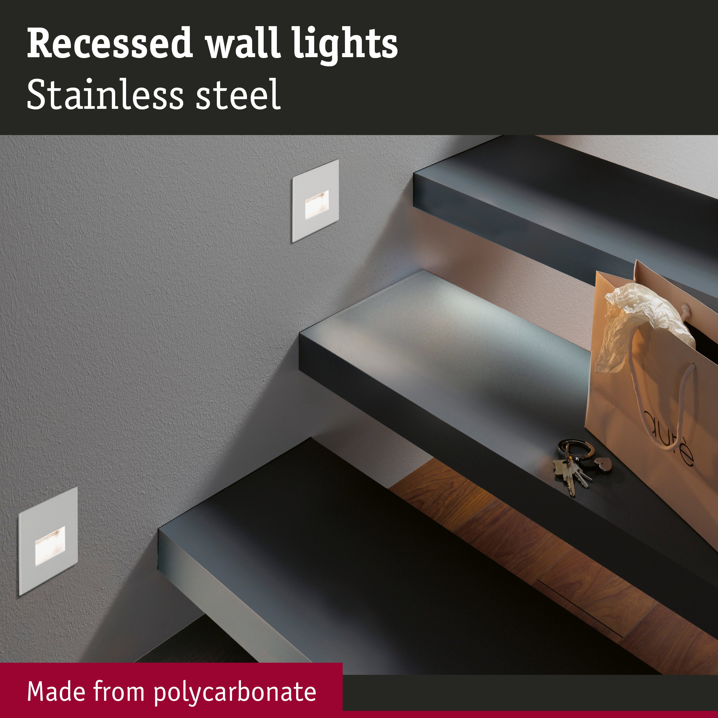 Recessed stainless steel wall light with polycarbonate illuminating stairs in modern home interior.