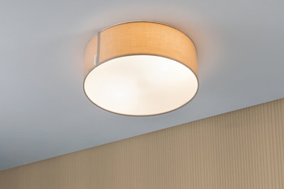 Round ceiling light with beige fabric shade and white diffuser for warm ambient lighting.