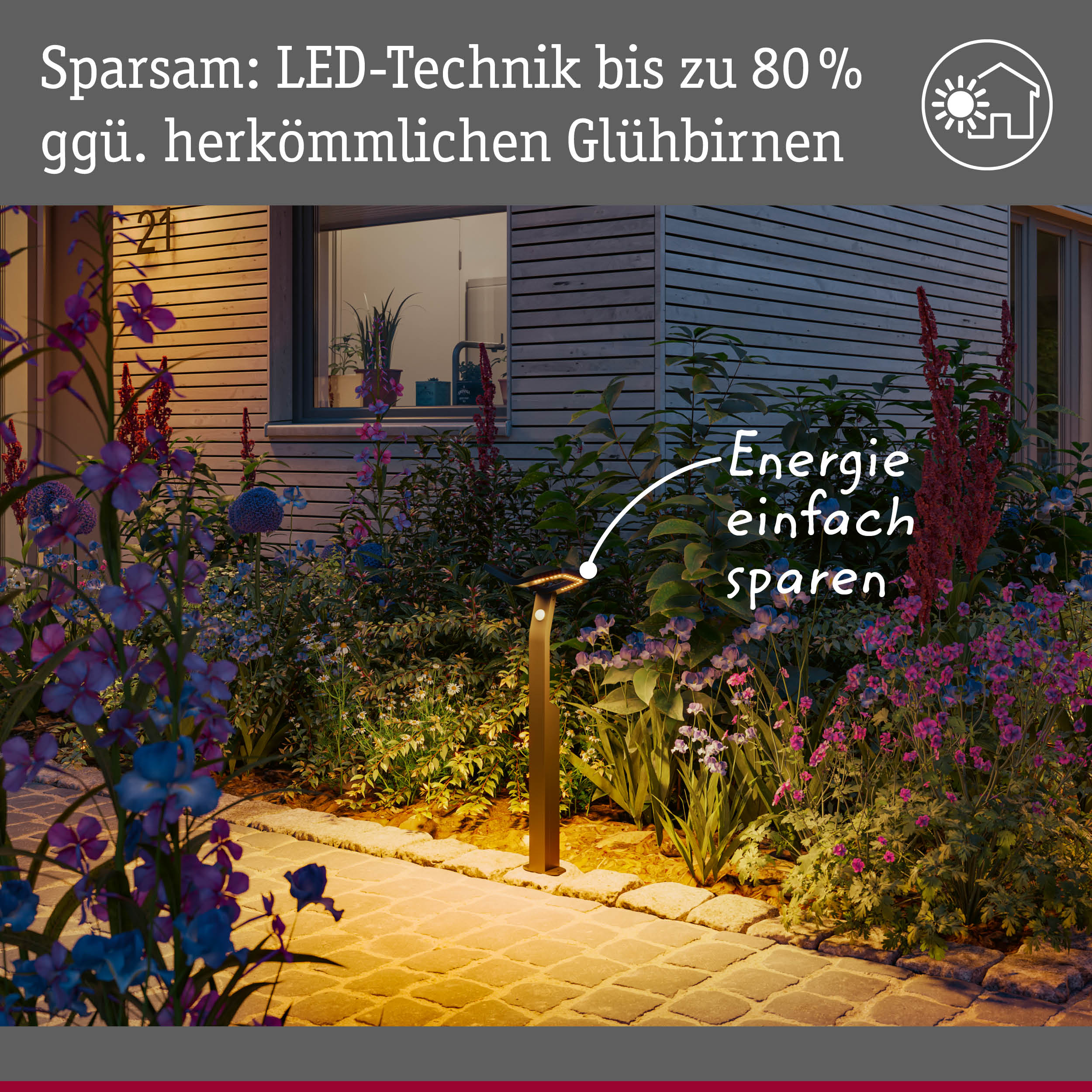 Gartenweg mit LED-Außenleuchte in warmweißem Licht, energiesparende Beleuchtung im Blumenbeet