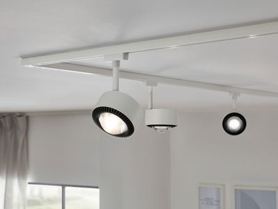 White LED track spotlights with black heat sink on white ceiling for modern room lighting