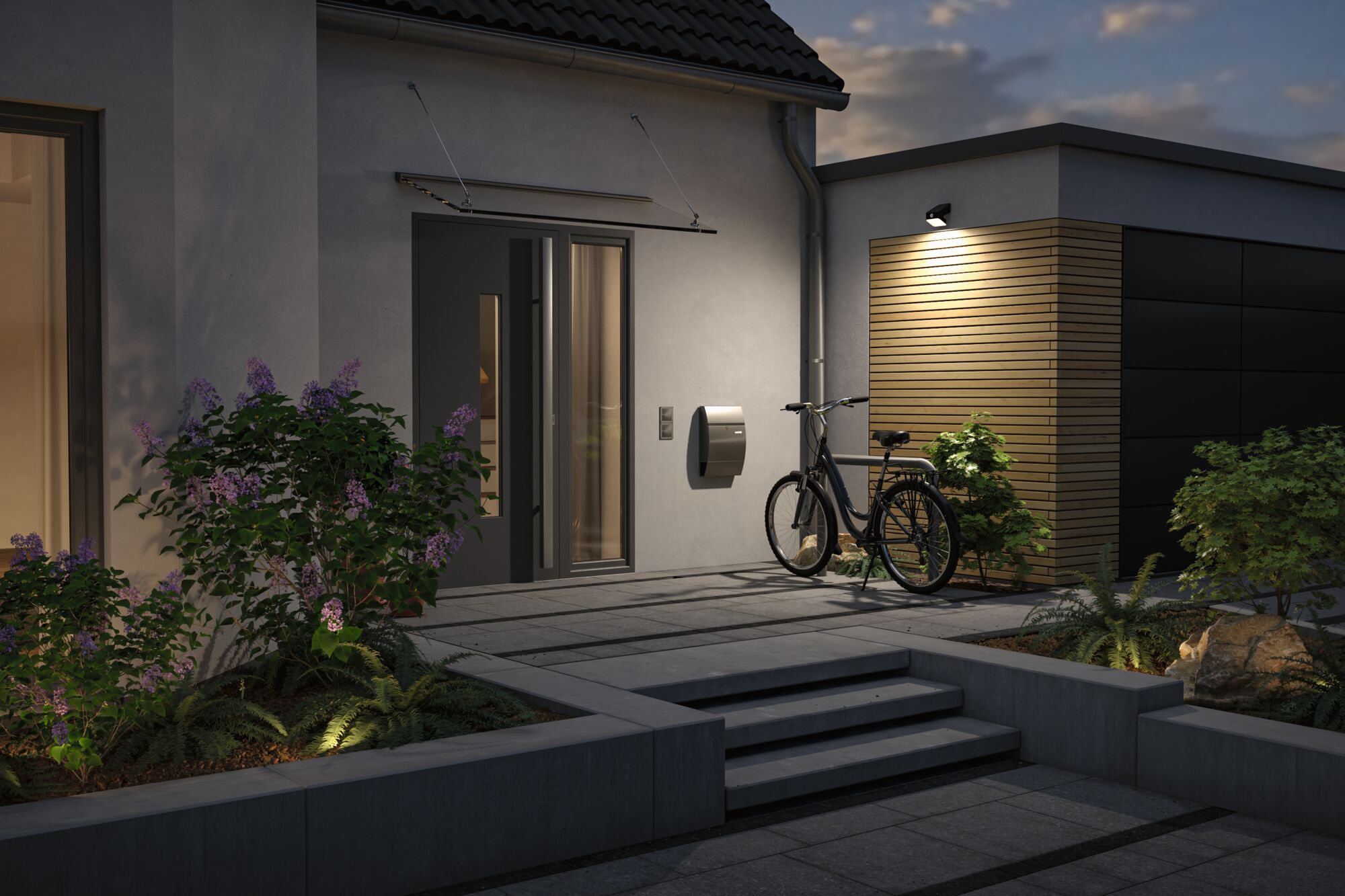 Modern house entrance with grey door, bicycle and outdoor wall light on wooden cladding at dusk