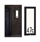 Black LED house number light with motion sensor and white panel for digits, modern outdoor lighting