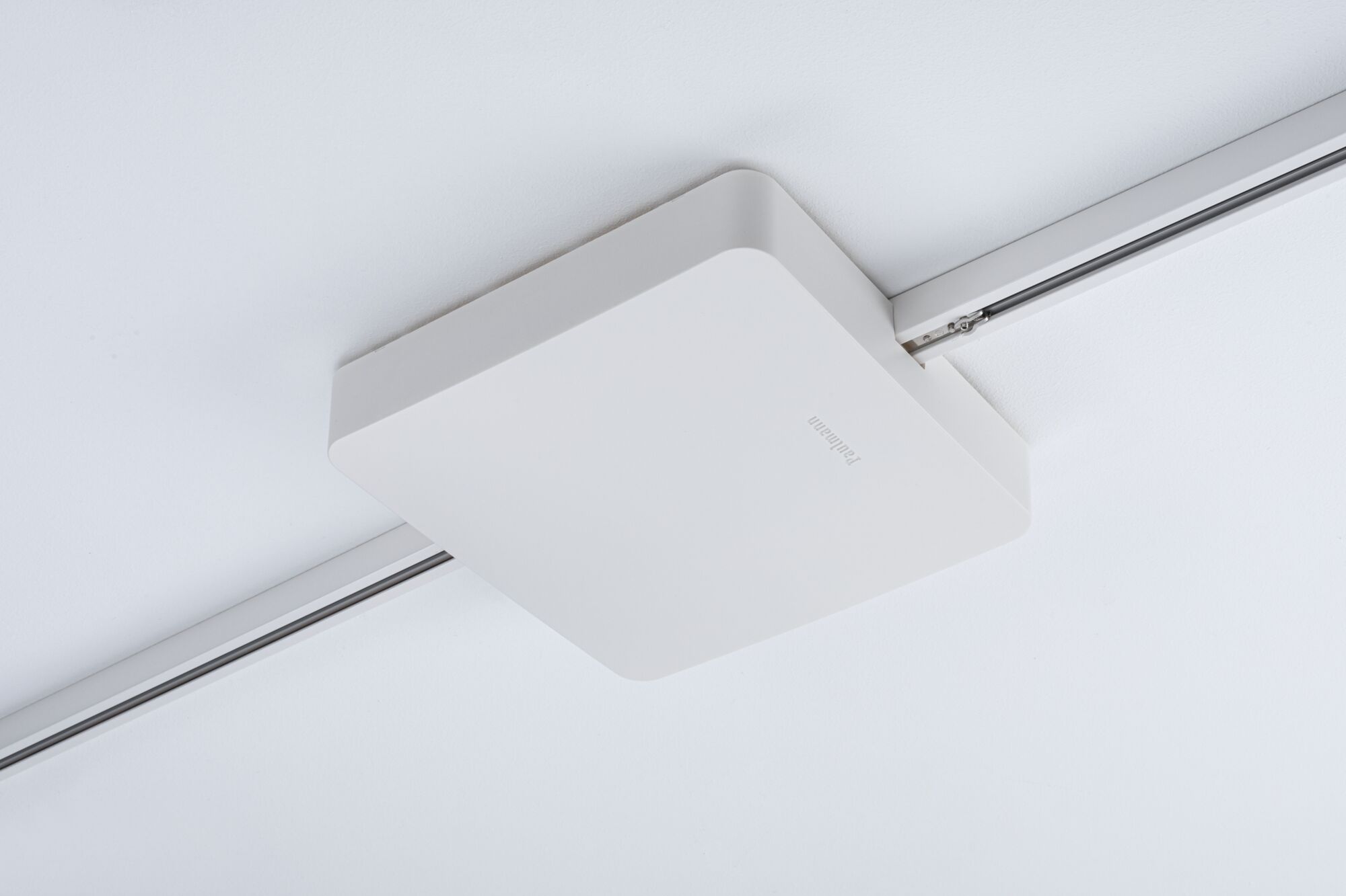 Square white plastic ceiling spotlight on track system for modern lighting solutions