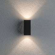 Schwarze LED-Wandleuchte aus Metall mit warmweißem Licht auf strukturierter grauer Wand