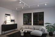 Modern living room with white LED track lighting on ceiling and grey Scandinavian style sofa