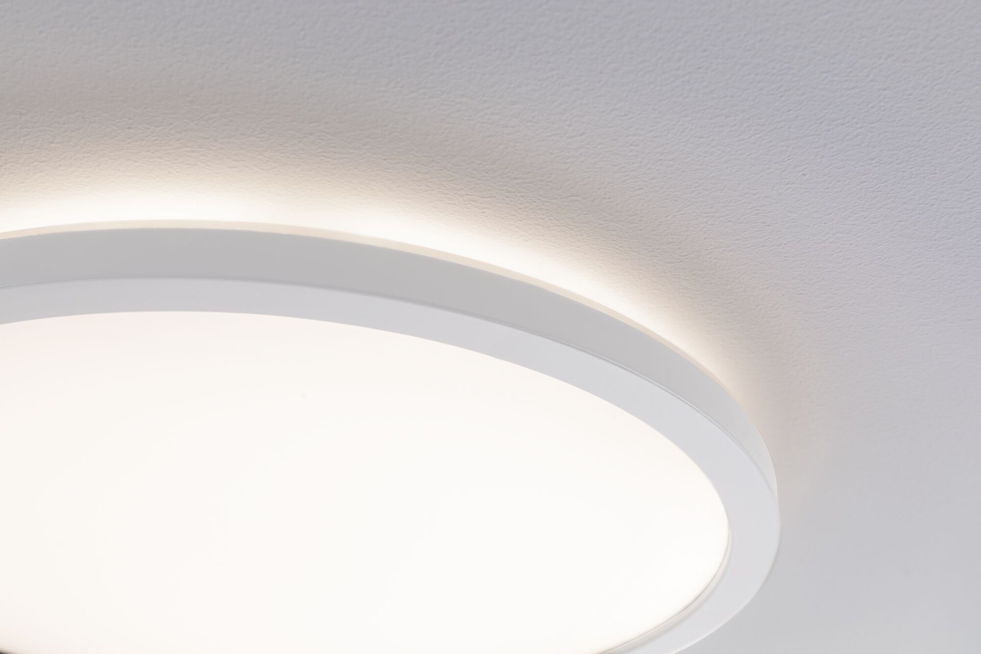 Runde weiße LED-Deckenleuchte mit indirektem Lichtschein an der Wand für modernes Raumlicht