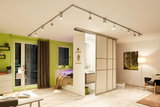Modern living room with white ceiling track system and adjustable LED spotlights for flexible lighting