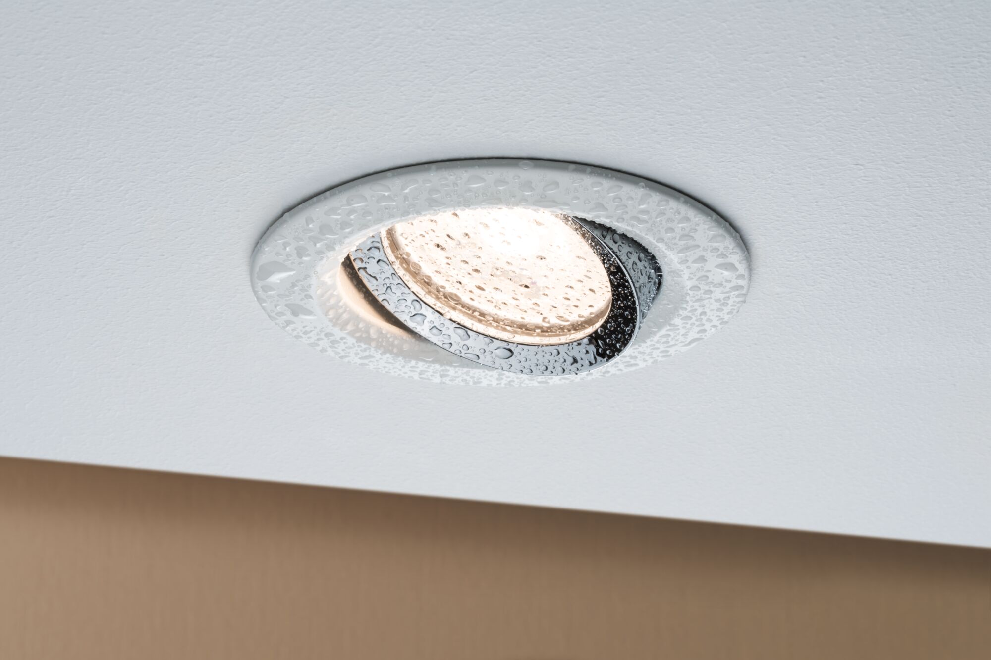 Moisture-resistant LED recessed spotlight with white frame and chrome ring, waterproof bathroom lighting