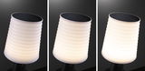 White LED solar light with ribbed plastic shade and black solar panel for outdoor lighting