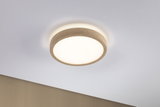 Round ceiling light with beige fabric edge and warm white light for modern interiors
