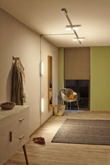 Modern hallway lighting with LED ceiling and wall lamps emitting warm white light for cozy rooms