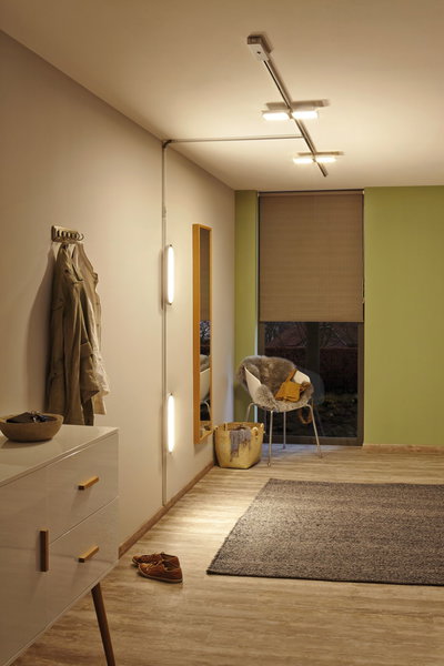 Modern hallway lighting with LED ceiling and wall lamps emitting warm white light for cozy rooms