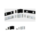 Vier zwarte en witte LED-strip connectors met pinnen voor flexibele lichtstrip montage