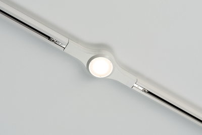 White LED track lighting with round ceiling spotlight in plastic for modern room illumination