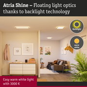 Atria Shine ceiling lights with warm white light and backlight technology in a modern living room