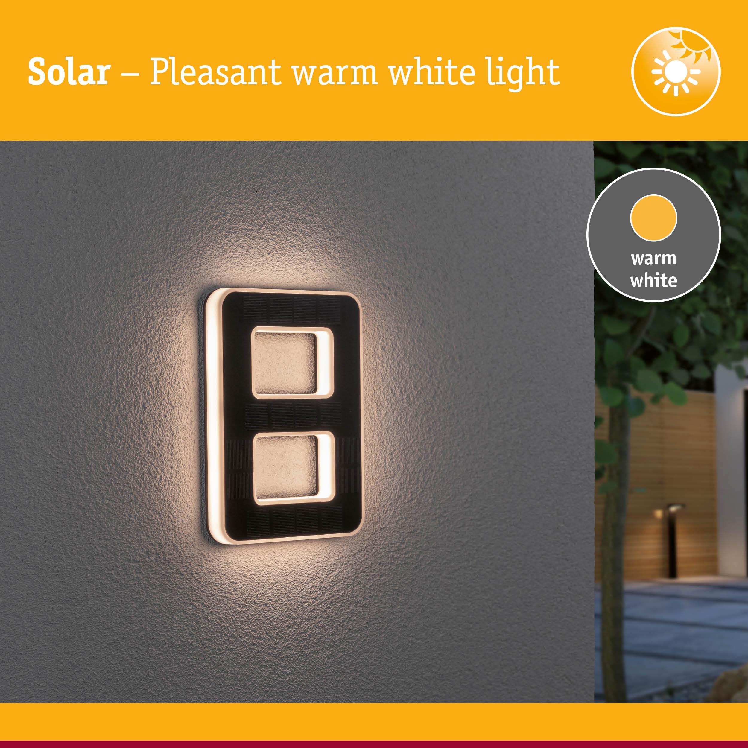 Solar-powered wall light with warm white light and modern rectangular design for outdoor lighting