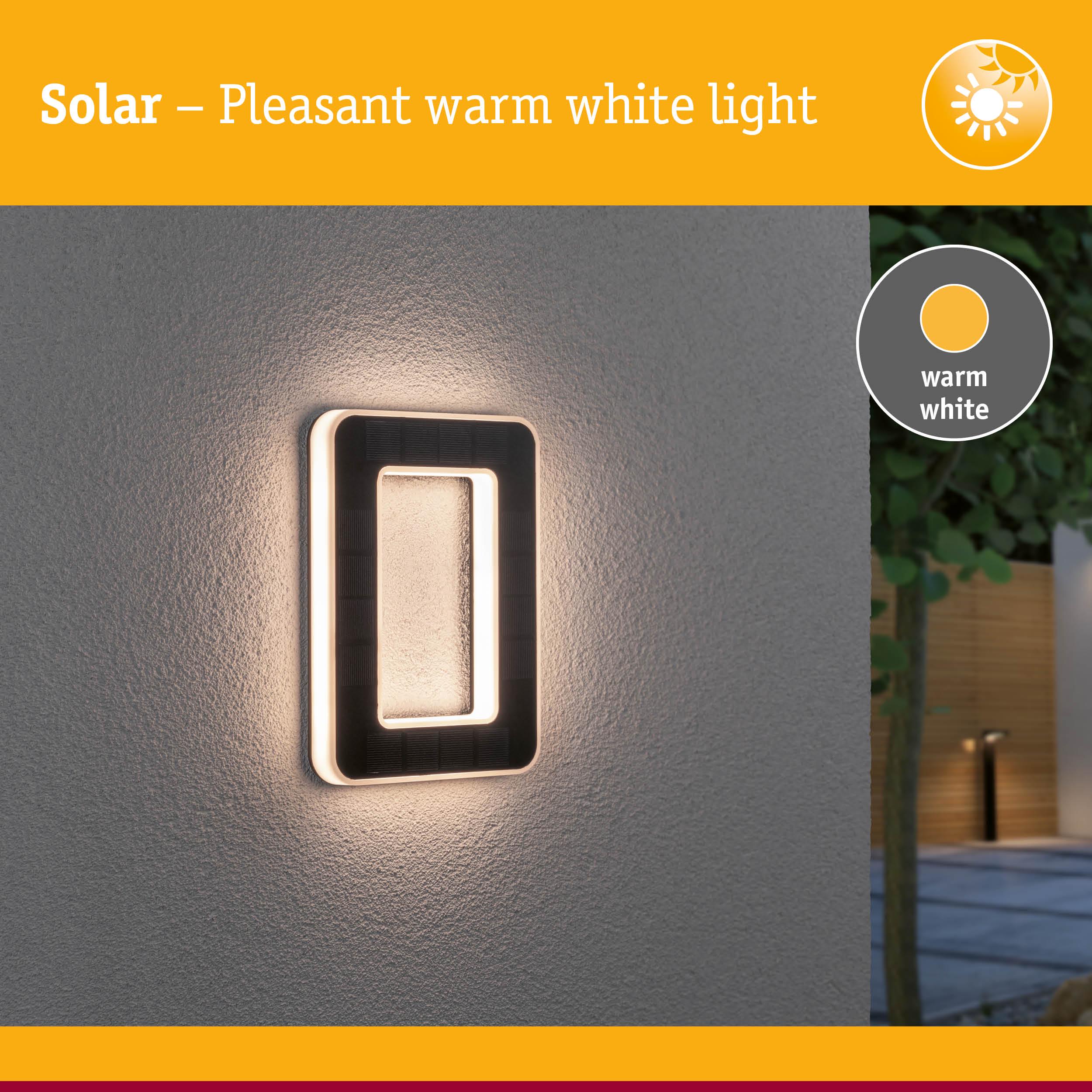 Solar-powered wall light with warm white glow and black rectangular frame for outdoor lighting