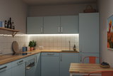 Modern kitchen with light blue wooden cabinets, wooden countertop and LED under-cabinet lighting for kitchen
