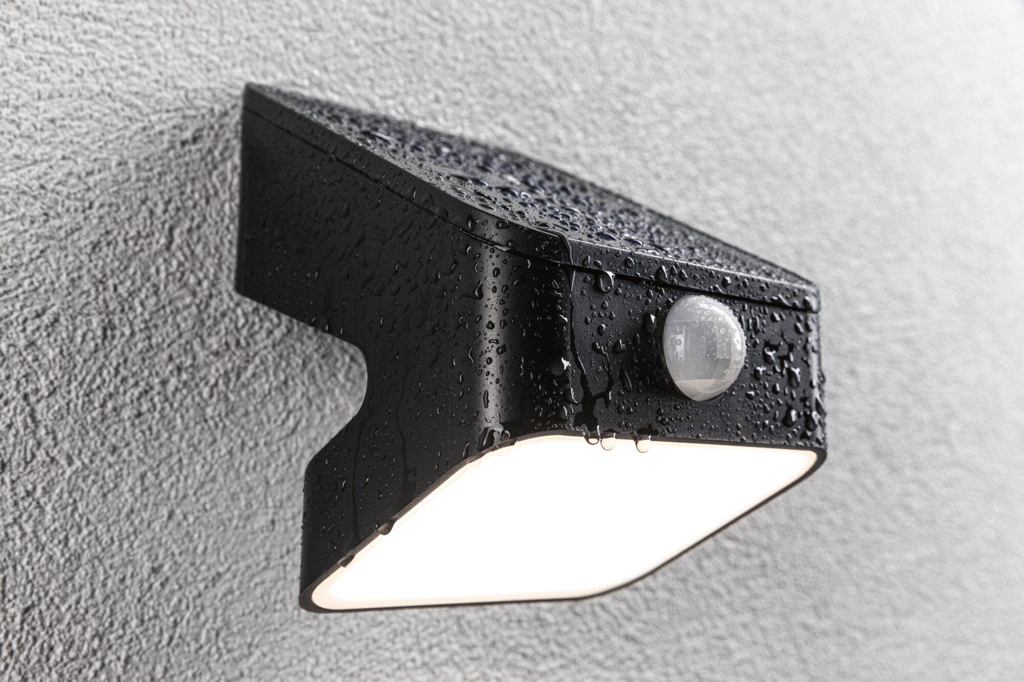 Black metal outdoor wall light with motion sensor and waterproof design for garden lighting