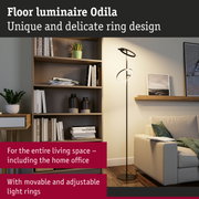 Black Odila floor lamp with movable, adjustable LED light rings in a modern living room setting.