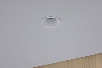 White recessed spotlight made of plastic integrated in ceiling for modern LED lighting