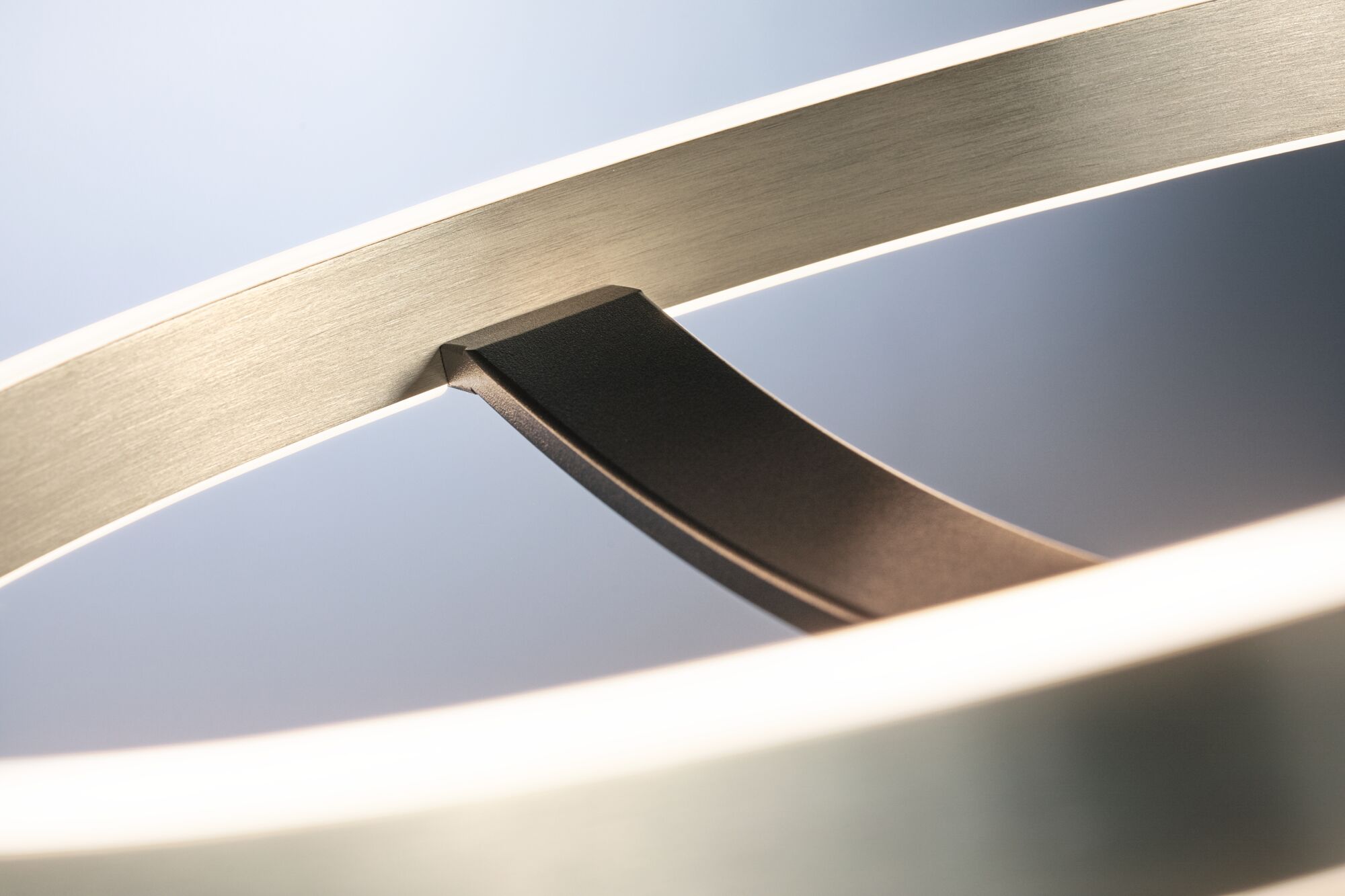 Close-up of modern LED ceiling light in brushed aluminium with black bracket detail