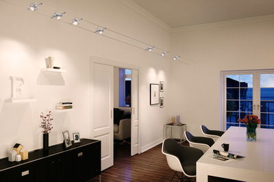 Modern silver cable spotlight with six adjustable heads for living room lighting.