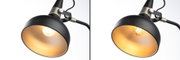 Black metal desk lamp with gold interior reflector and warm white LED bulb for office lighting
