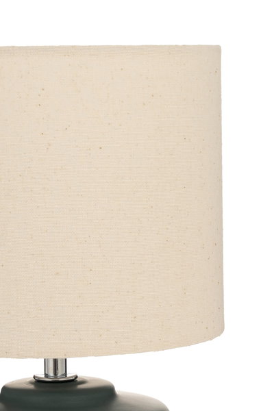 Table lamp with cream fabric shade and dark green base for cozy ambient lighting