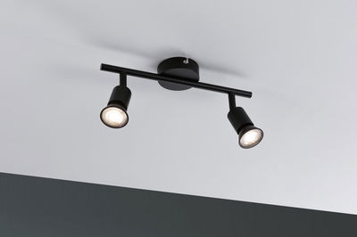 Plafonnier noir avec deux spots réglables en métal pour un éclairage moderne.