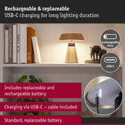 Beige table lamp with replaceable battery and USB-C charging cable for extended lighting duration