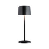 Black metal table lamp with ribbed shade and warm white LED light for modern home lighting